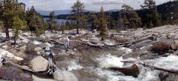 Accommodation Tahoe vacation guests enjoying a wilderness hike near a waterfall at Cascade Lake just minutes from their condo.