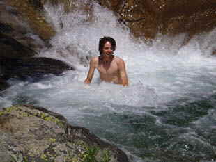 An accommodation tahoe vacation rental guest cools off in a mountain pool on a Cascade Falls hike.